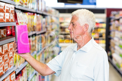 Senior man holding pink box