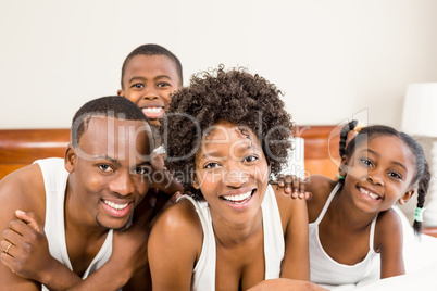 Happy family lying on the bed