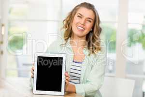 Blonde woman showing tablet screen