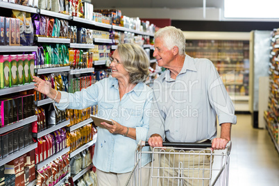 Smiling senior couple buying food