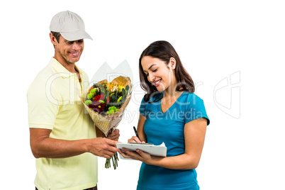Flower delivery man taking signature of beautiful woman