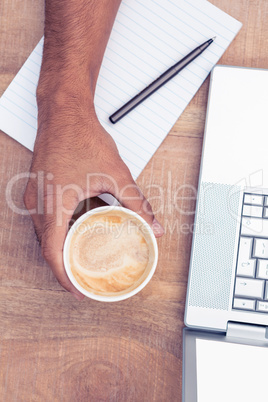 Overhead view of businessman having coffee