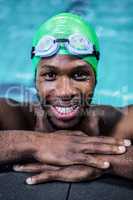 Smiling fit man in the swimming pool