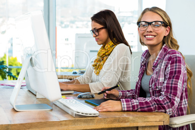 Two girls work at office