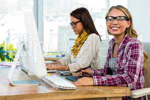 Two girls work at office