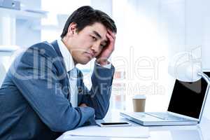 Tired businessman holding his head