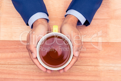 Cropped hands of businessman holding coffee cup Cropped hands of businessman holding coffee cup