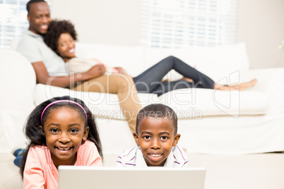 Happy kids using laptop pc