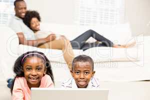 Happy kids using laptop pc