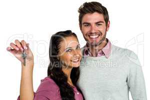 Cheerful couple holding keys