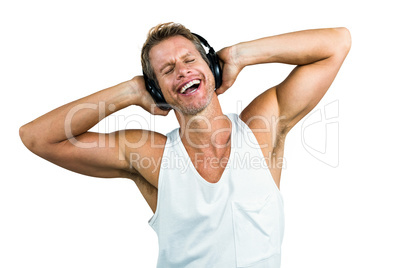 Happy man hearing music with headphones