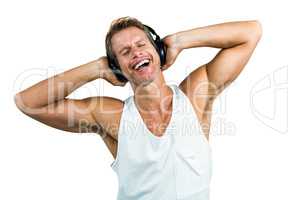 Happy man hearing music with headphones