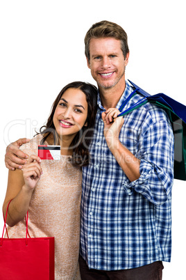 Portrait of happy couple with shopping bags and credit card