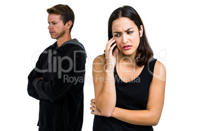 Depressed couple standing against white background