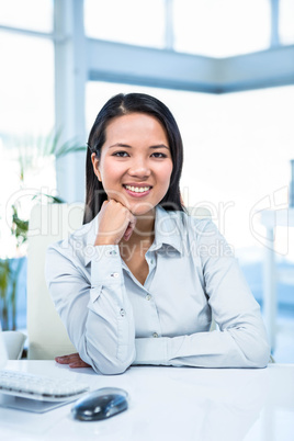 Smiling businesswoman with chin on fist Smiling businesswoman with chin on fist