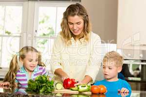 Happy family slicing vegetables