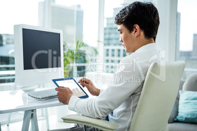 Asian businessman using his tablet