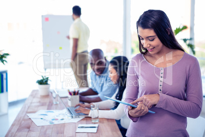 Young businesswoman using tablet PC in conference room