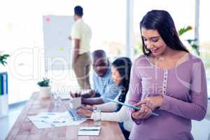 Young businesswoman using tablet PC in conference room