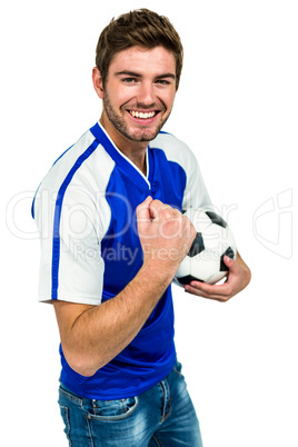 Portrait of handsome man holding football