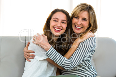 Mother and daughter smiling together