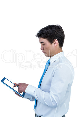 Serious asian businessman using his tablet