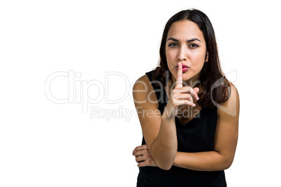 Portrait of woman with finger on lips