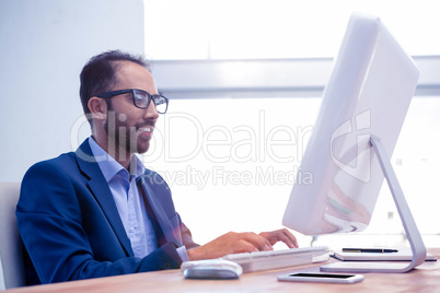 Businessman working on computer while sitting in office