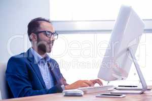 Businessman working on computer while sitting in office