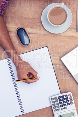 Businessman writing on notebook