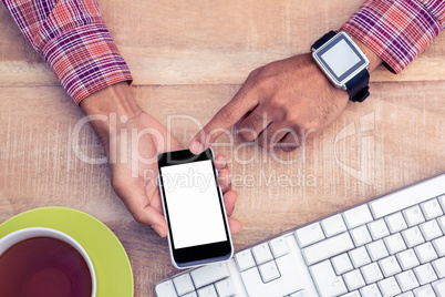 Man using smart phone on desk