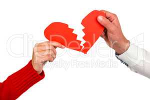Cropped hands of couple holding cracked red heart shape