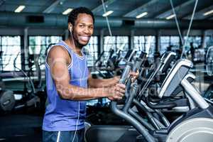 Smiling man working out with headphones on