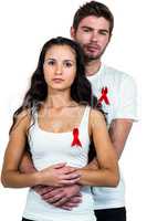 Portrait of couple hugging with red ribbons