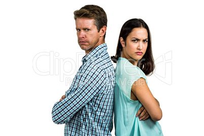 Portrait of angry couple standing back to back