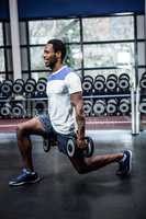 Smiling man exercising with dumbbells