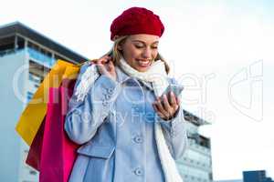 Girl looking at her phone during shopping