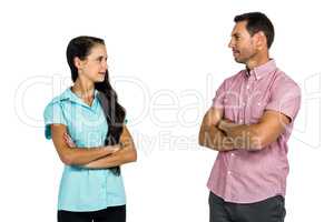 Couple looking at each other with arms crossed