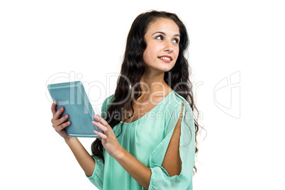 Smiling woman holding tablet and looking away