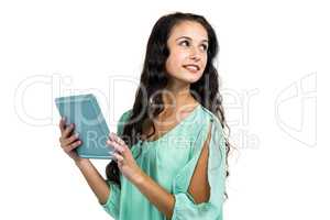 Smiling woman holding tablet and looking away