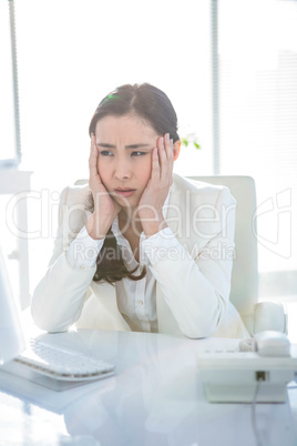 Stressed businesswoman working at her desk