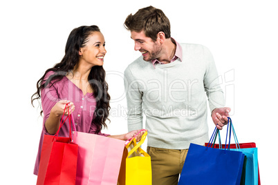 Stylish couple holding shopping bags