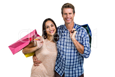 Portrait of cheerful couple with shopping bags