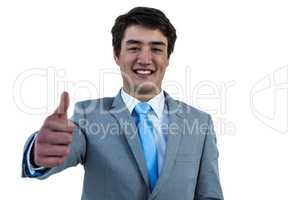 Smiling asian businessman showing thumbs up