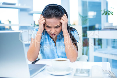 Stressed businesswoman working at her desk