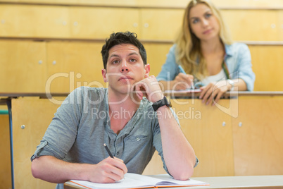 Thoughtful male student during class