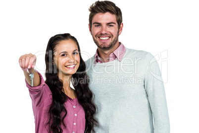 Portrait of happy couple holding keys