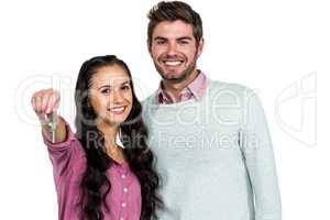 Portrait of happy couple holding keys