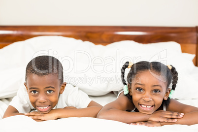 Brother and sister lying in the bed