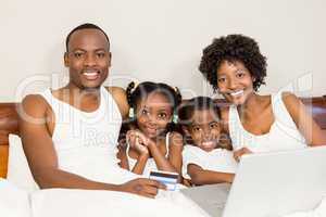 Happy family lying in bed together